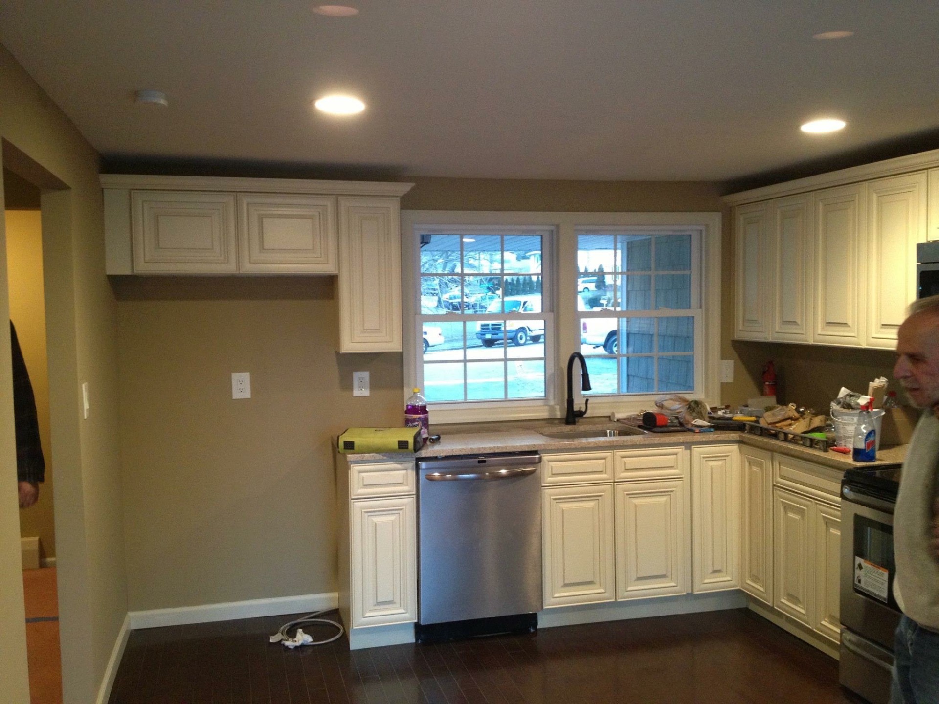 Finished kitchen with new cabinets, counters, and recessed lighting
