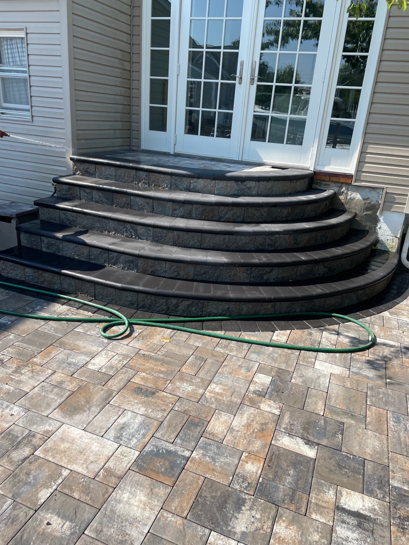 Finished curved masonry steps and paver landing